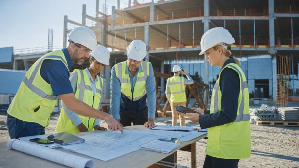 TCA team reviewing plans together at an active construction site