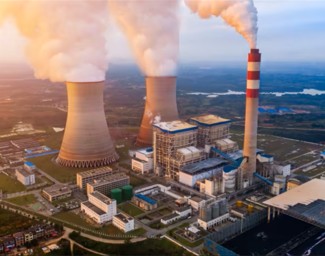 Aerial view of a power plant facility at dusk